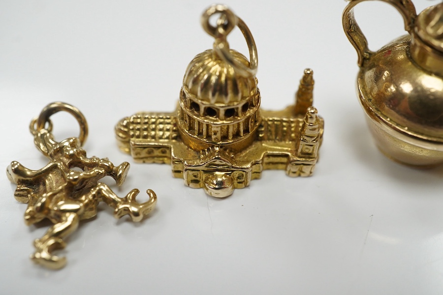 Three assorted 9ct gold charms, including Guernsey milk can and 'Ye Olde Smithy' and one other yellow metal charm, gross 14 grams. Condition - fair to good